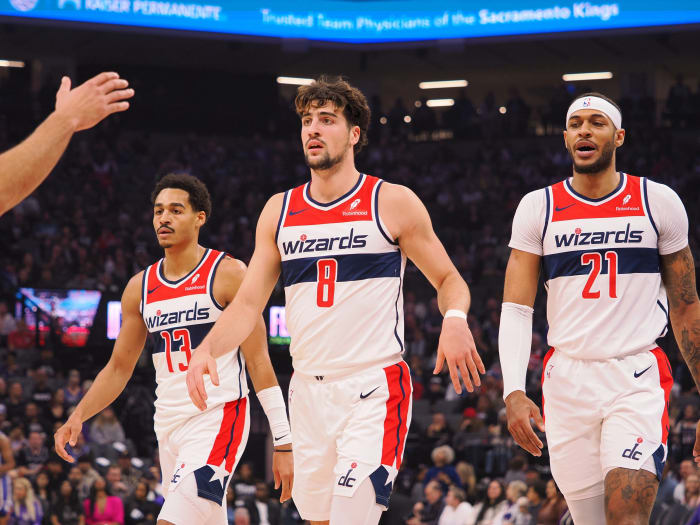 Washington Wizards guard Jordan Poole (13) and forward Deni Avdija (8) and center Daniel Gafford (21) during a time out called against the Sacramento Kings during the first quarter at Golden 1 Center.